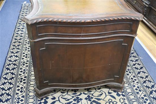 A serpentine pedestal desk, 135cm wide